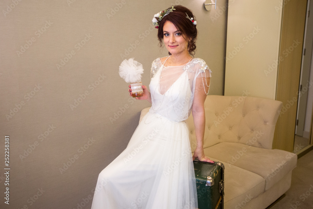 Beautiful model in wedding dress posing in hotel room Beautiful model in wedding dress posing in hotel room