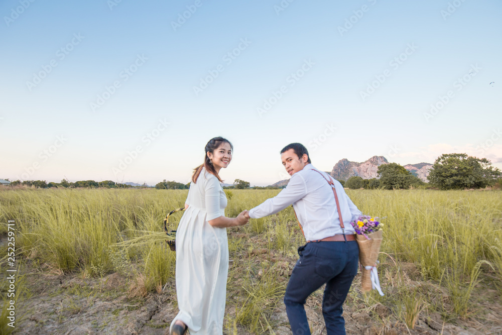 Couple of love running together in green field Couple of love running together in green field