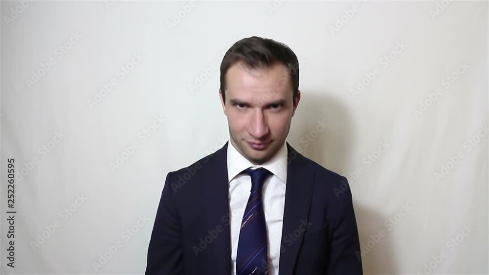 Young handsome businessman nods his head approvingly.Portrait on a white background.