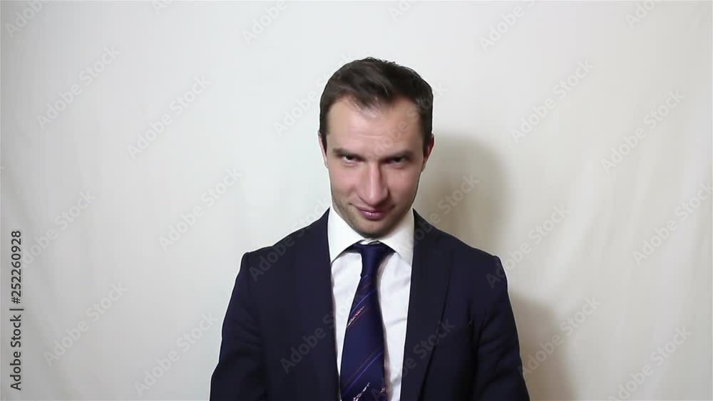 Young handsome businessman says yes and nods his head.Portrait on a white background. Young handsome businessman says yes and nods his head.Portrait on a white background.