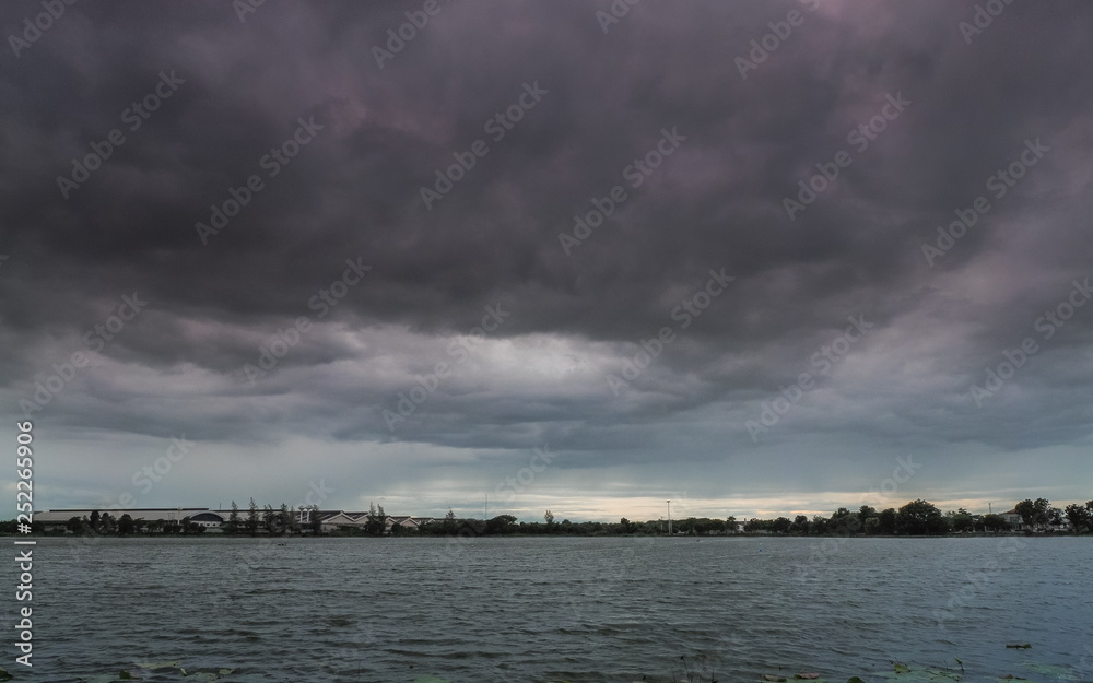 Lake view of dark clouds moving in strong wind with rain storm above the lake, Krajub reservoir in Banpong District, Ratchaburi, Thailand.