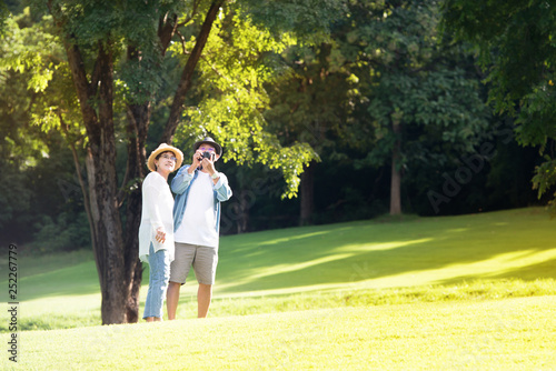 Image of happy romantic Asian senior couple outdoor in park © amenic181