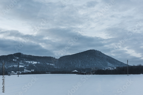 scenic view of snowy carpathian mountains and cloudy sky in winter
