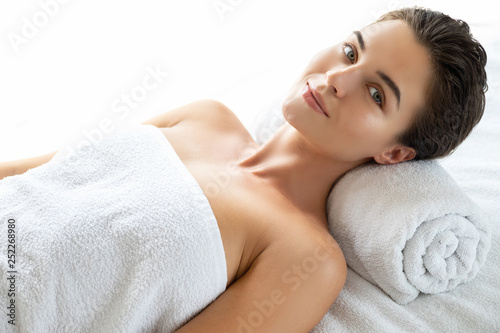 Young and beautiful woman is lying and relaxing after massage session