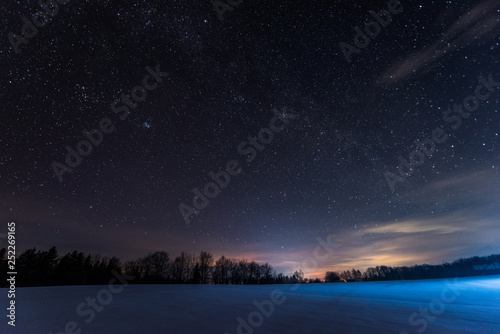 dark sky full of shiny stars in carpathian mountains in winter at night photo