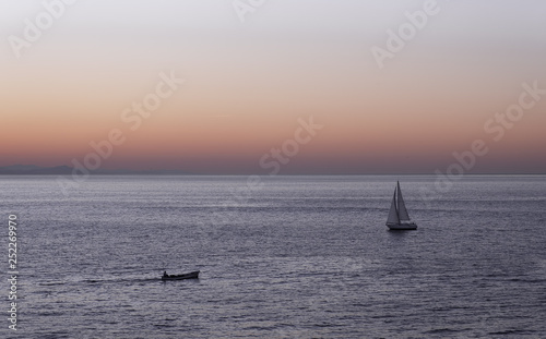 Boats sailing on the coast of the city of Donostia at sunset, Euskadi. © poliki