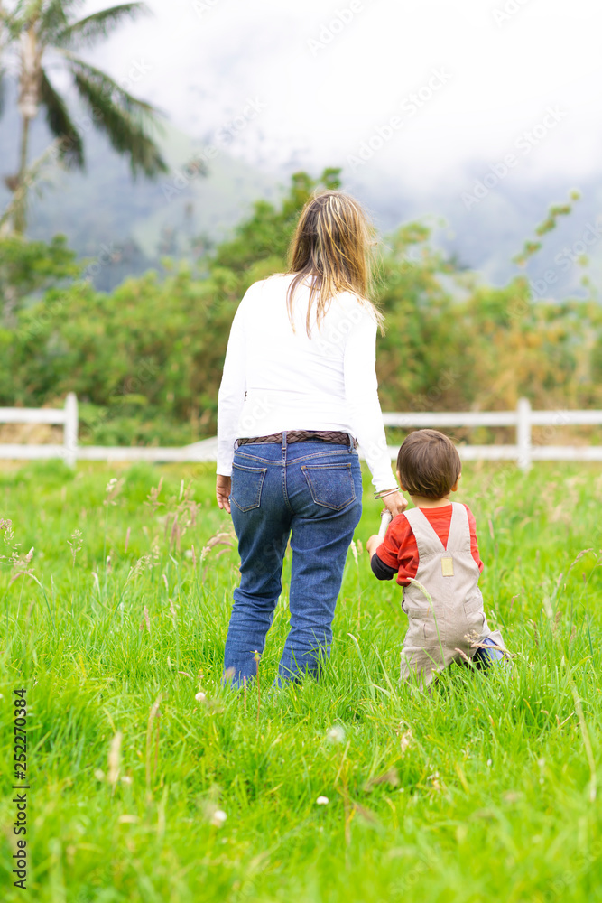 Fototapeta premium Lovely mother and boy walking outdoors