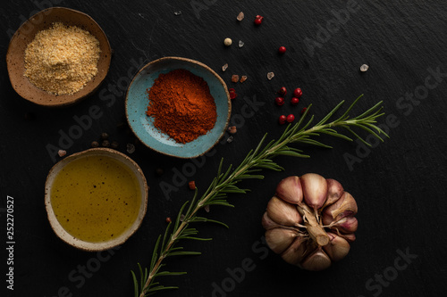 spices and herbs on black background