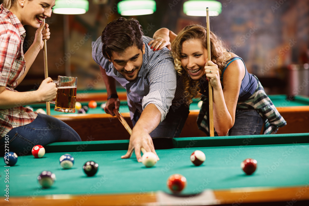 Friends play billiards., Stock image