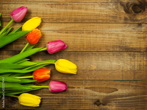 Yellow tulips on wooden background copy space