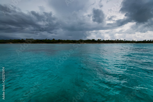 Dominican coast distant view from water on cloudy day