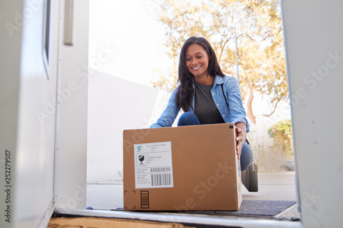 Woman Coming Back To Home Delivery In Cardboard Box Outside Front Door