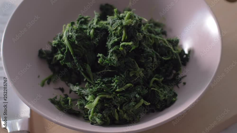 Blanched spinach in a bow. Slow motion Blanched spinach in a bow. Slow motion