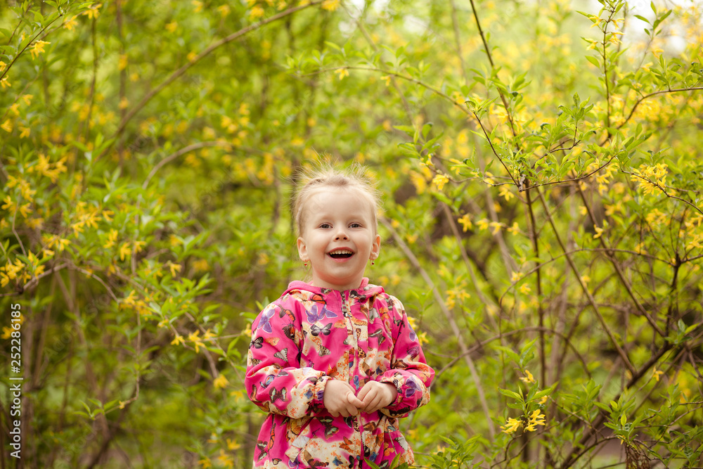 happy cute girl 3-4 years old portrait outdoors in spring in the park