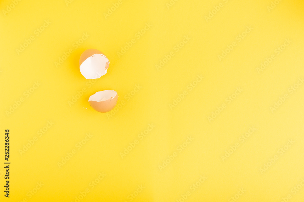 egg shell split and open on yellow background