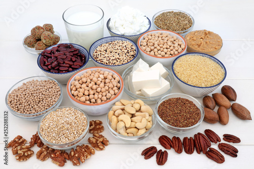 Vegan health food selection with bean curd, legumes, nuts, seeds, quinoa vegetable balls, cereals, almond milk, butter and yoghurt. Super foods high in antioxidants, dietary fibre, omega 3 & vitamins.