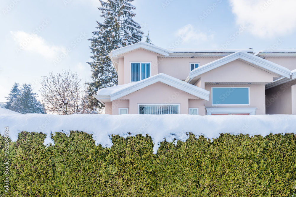 Houses in suburb at Winter in the north America. Fragment of luxury house covered nice snow.