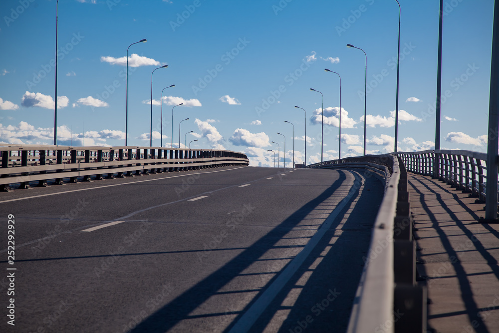 Highway with road markings. Road over the bridge. The road goes to the sky.