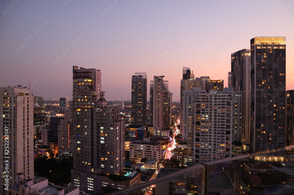 Skyscrapers view of Bangkok downtown after the sunset as seen from rooftop terrace