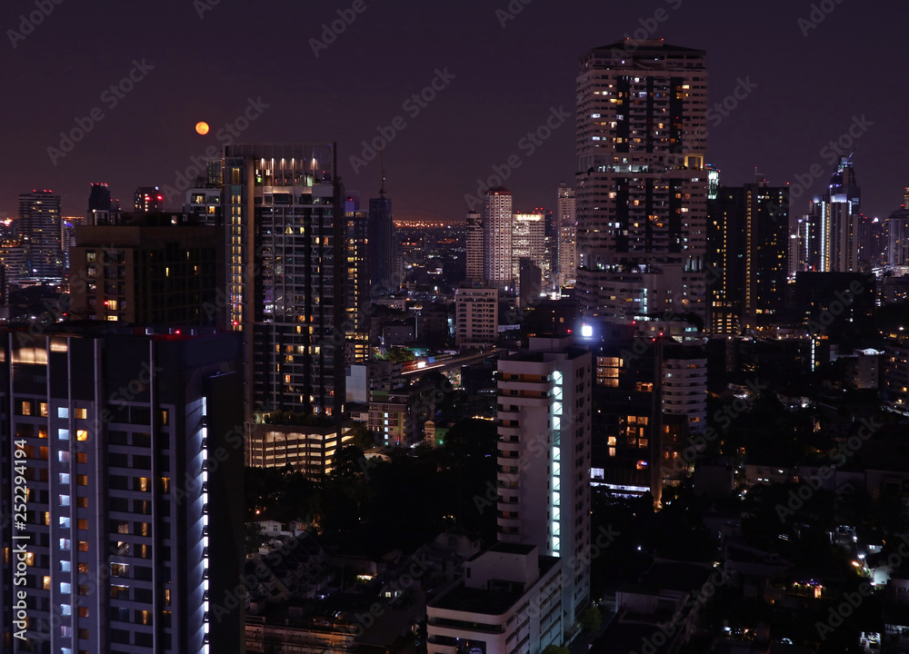 Skyscrapers view of Bangkok downtown on the bright full moon night 