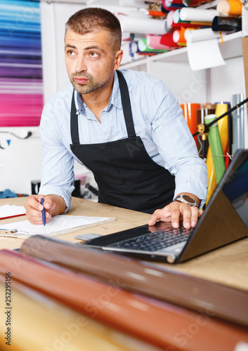 portrait of working advertising agency behind a laptop