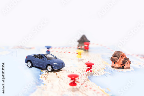 Abstract idea of rent a car. Small car on map. Abstract travel photo