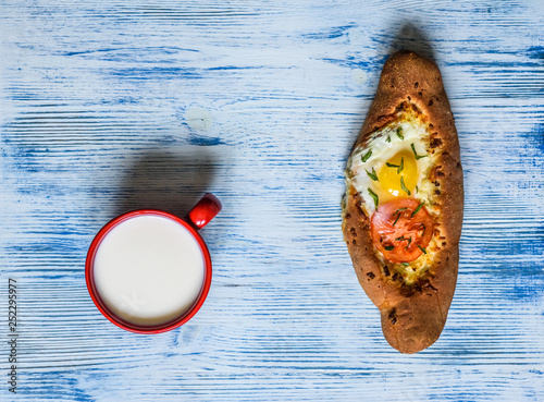 Georgian Khachapuri bread on a wooden background