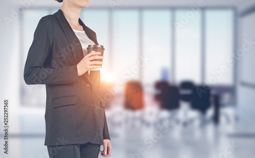 Businesswoman with coffee in meeting room