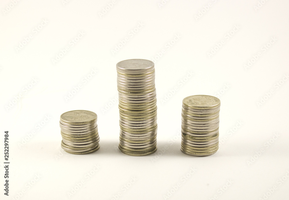 three stacks of coins on a white background, rubles three stacks of coins on a white background, rubles