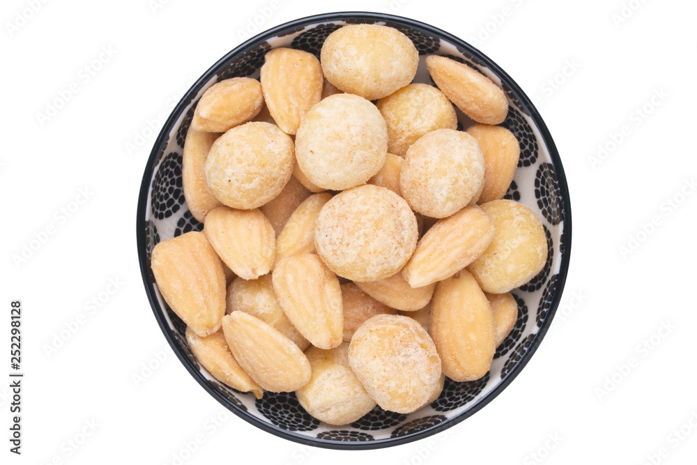 Nuts background. Close-up of roasted and salted macadamias and almonds nuts in ceramic bowl isolated on a white background. Gourmet nut mix with macadamias. Macro. Top view. Nuts background. Close-up of roasted and salted macadamias and almonds nuts in ceramic bowl isolated on a white background. Gourmet nut mix with macadamias. Macro. Top view.