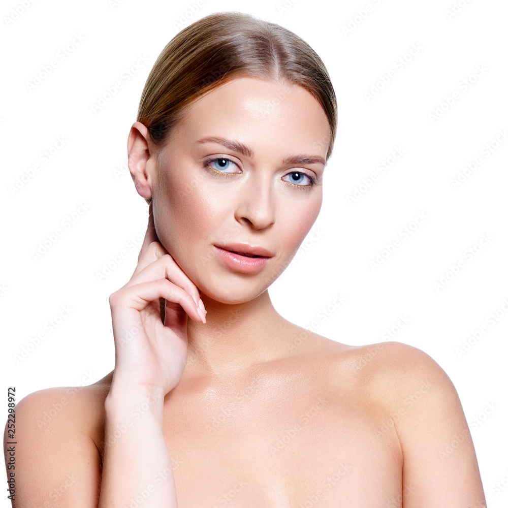 Beauty Portrait. Beautiful Spa Woman Touching her Face. Perfect Fresh Skin. Isolated on White Background. Pure Beauty Model. Youth and Skin Care Concept