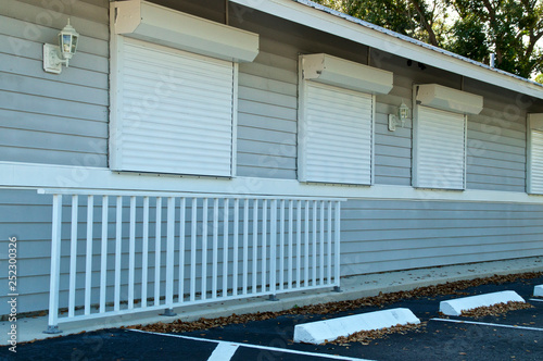 View of small generic florida building with hurricane shutters closed.