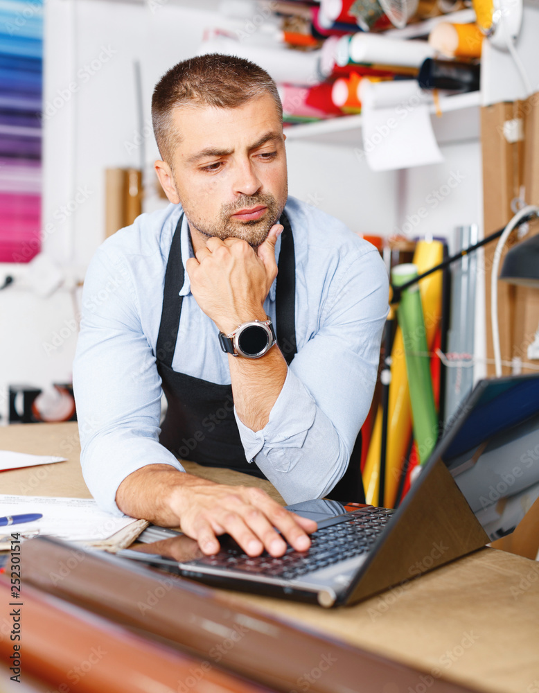 portrait of working advertising agency behind a laptop portrait of working advertising agency behind a laptop