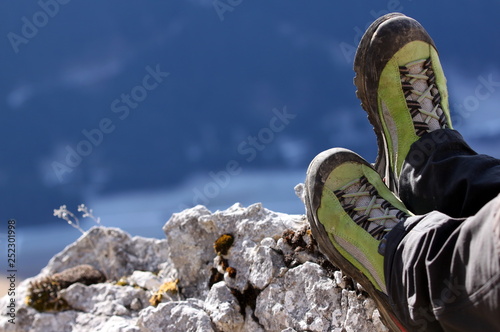 close up from mountain boots and legs on a rock