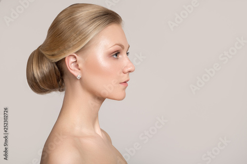Young woman with hairstyle bun. Clean skin and hair concept