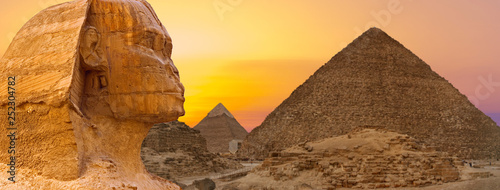 Sphinx against the backdrop of the great Egyptian pyramids. Africa, Giza Plateau.	