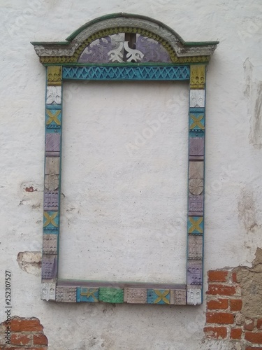 old wooden window frames on a white brick wall