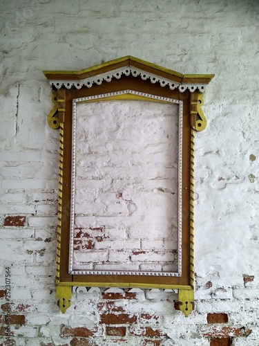 old wooden window frames on a white brick wall