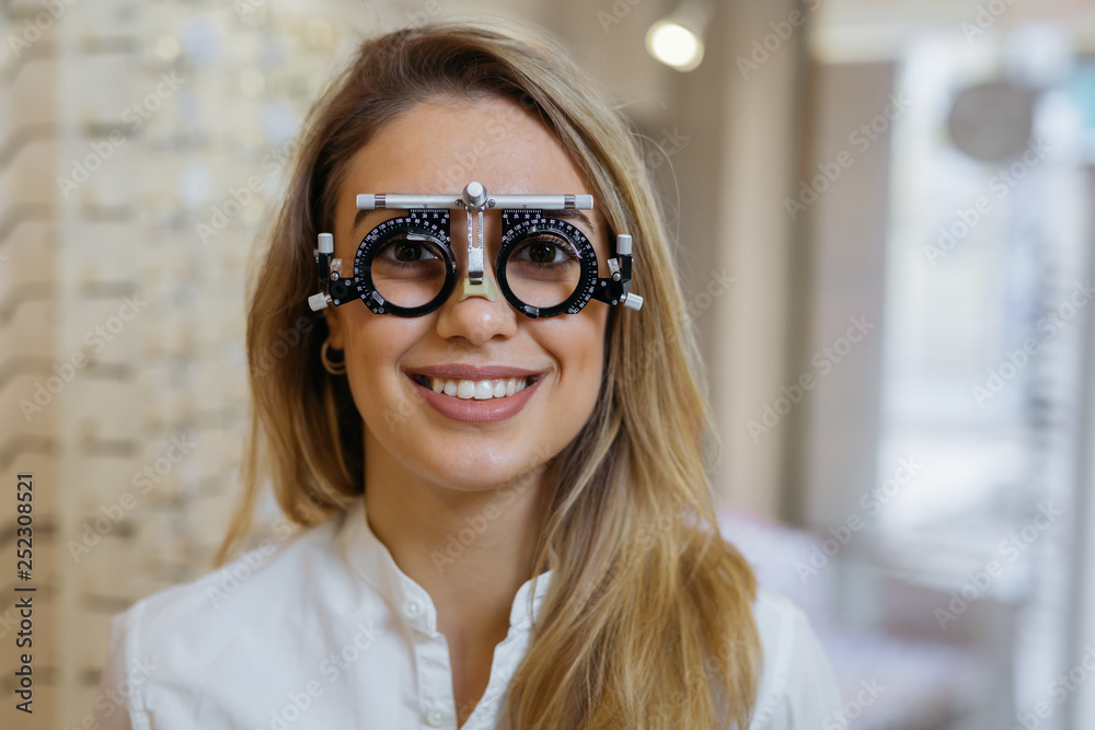 woman wearing trial frame in clinic and looking at the camera woman wearing trial frame in clinic and looking at the camera