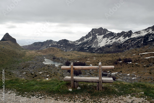 Alone wooden bench with beautiful Mountains view. Durmitor National Park, near Zabljak, Montenegro.