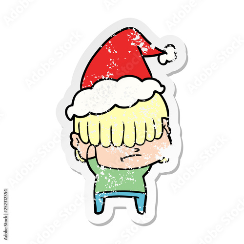 distressed sticker cartoon of a boy with untidy hair wearing santa hat