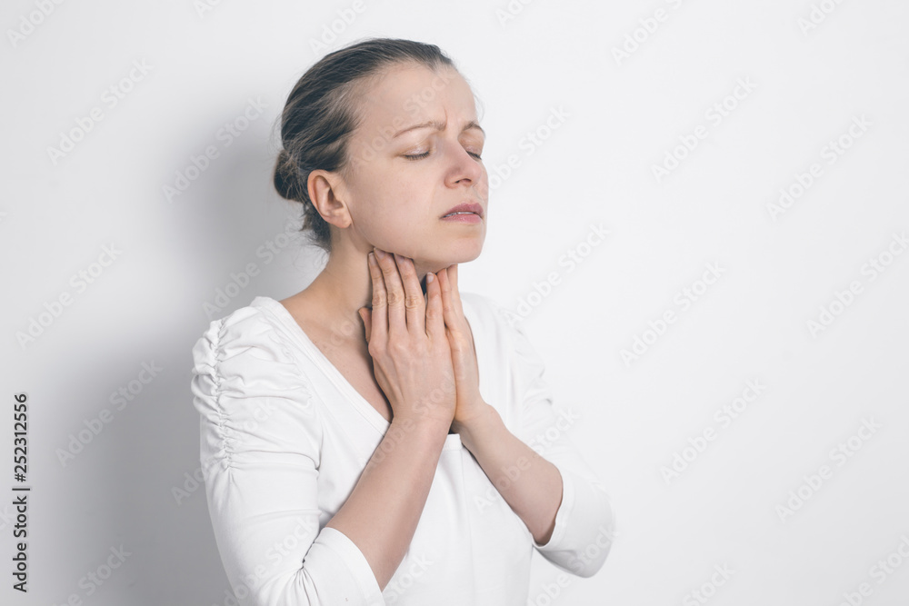 Angina. A woman holding her sore throat. Inflamed thyroid gland. Angina. A woman holding her sore throat. Inflamed thyroid gland.