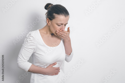Fotografie Nausea in a woman. Pregnancy. Vomiting. Food poisoning.
