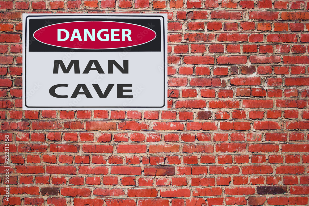 sign danger man cave on red brick wal sign danger man cave on red brick wal