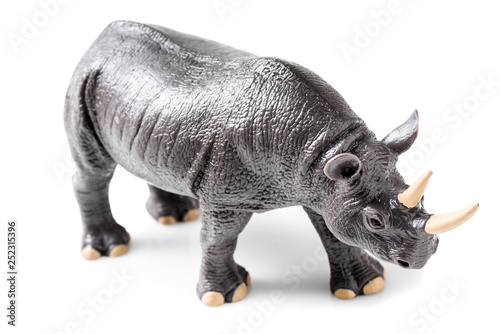 Rhino plastic figurine on white background © Adriana