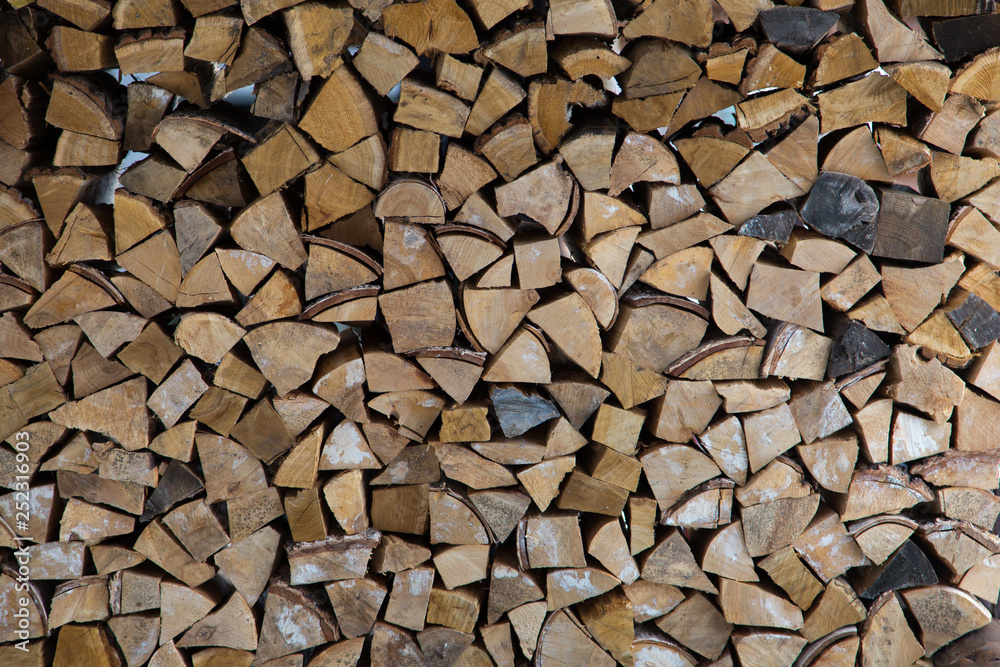 wall of wood and logs in the snow wall of wood and logs in the snow