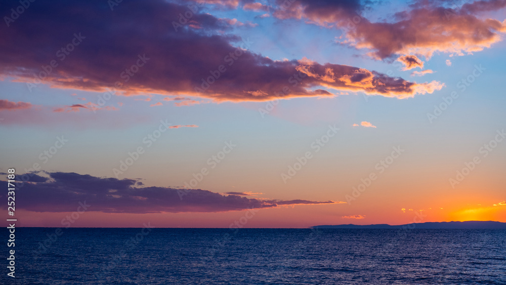 Amazing sunset and horizon seaside view, colorful clouds in the sky