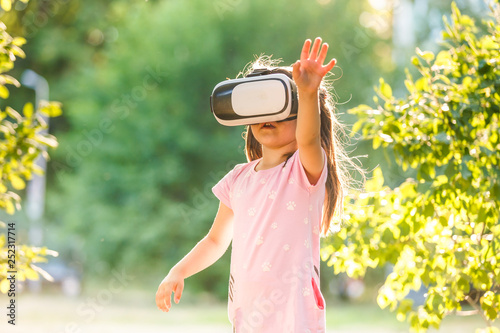 Digital technology virtual reality glasses 3d. Child plays in sertraline reality. photo