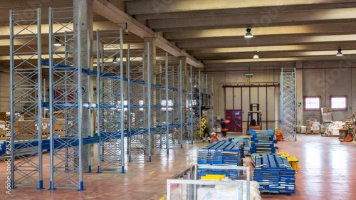 timelapse of industrial shelving assembly, workers at work in a warehouse of an Italian company