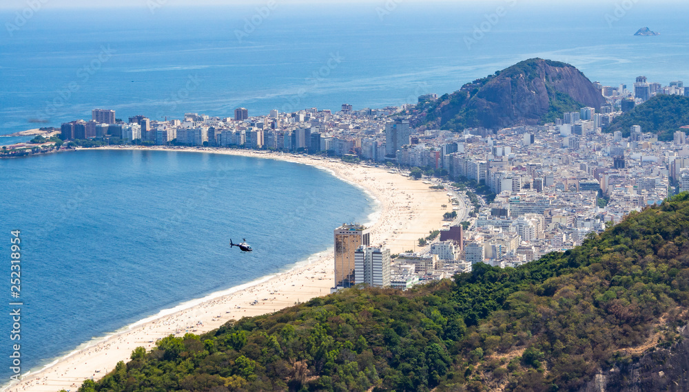 Majestic drone view of distant helicopter flying over sandy beach and modern coastal city in Brazil Majestic drone view of distant helicopter flying over sandy beach and modern coastal city in Brazil